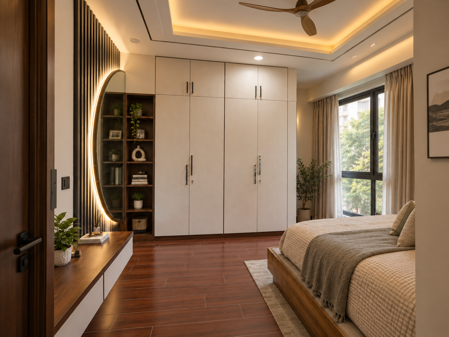 Warm-lit bedroom with a fluted wardrobe, round mirror and wood flooring